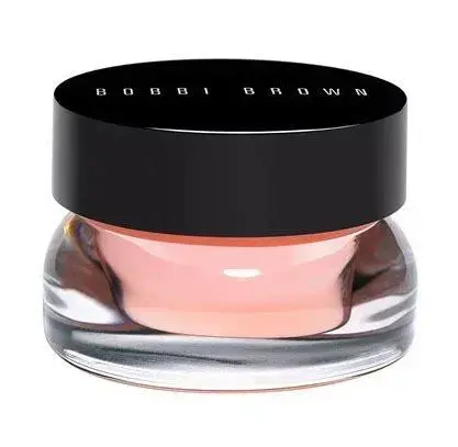 Photo of a little glass jar closed with a black plastic lid against a white background. The jar has a pink balm inside.