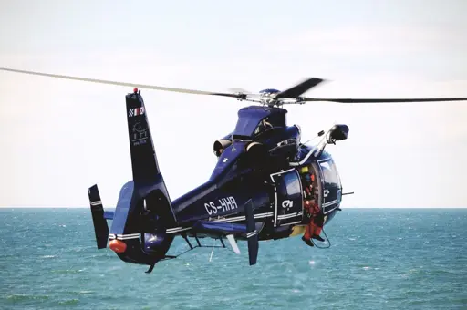 A coastguard helicopter engaged in a ship boarding drill.