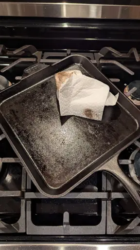 My cast iron pan on the stove, showing how oily it is. 